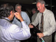 Gary Kelman, of the Land Management Administration, examines his plaque for 30 years of service.