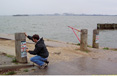 Man putting up signs on a post