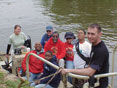 MDE's Renee Godinez and a volunteer remove a tire from the Anacostia River.