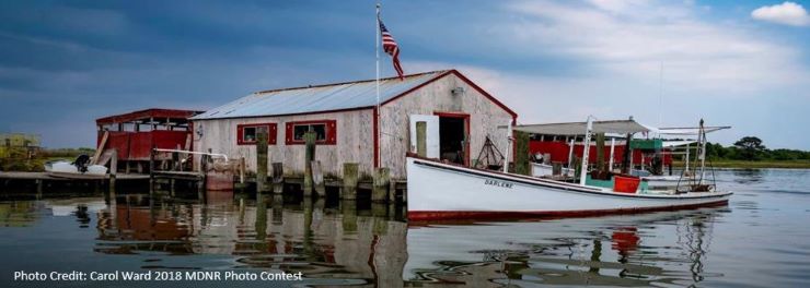 Image of boat house next to dock with boat