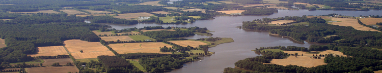 Aireal view of farmland with a river running through it